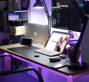 Wooden desk setup with Apple devices and lilac accents representing Blockchain Squad's branding.