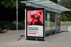 ClientCare bus stop ad with the phrase "Focus on care, not paperwork" in a tree-lined urban setting.