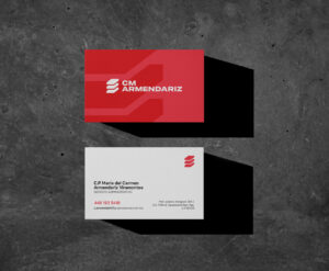 construction company brand identity CM Armendariz business cards on a concrete background.