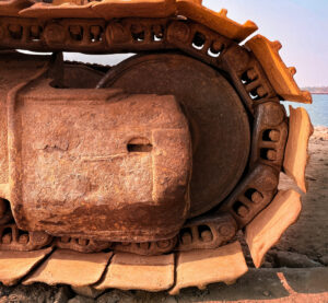 Close-up of construction machine tires at a worksite.