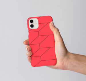 Phone case in CM Armendariz red with branded texture.