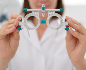 Ophthalmologist holding an optical diagnostic device, prepared for an eye examination.