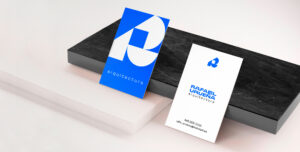 architect brand identity Two Rafael Urueña business cards on black and white marble stones, featuring architectural branding elements.