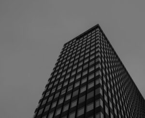 Grayscale photograph of a modern architectural building with clean geometric lines.