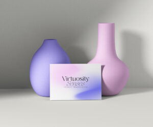 candle brand identity Virtuosity Senses business card leaning against two ceramic vases in soft colors.