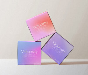 candle brand identity Three stacked candle boxes in soft brand colors, representing Virtuosity Senses’ premium packaging design.