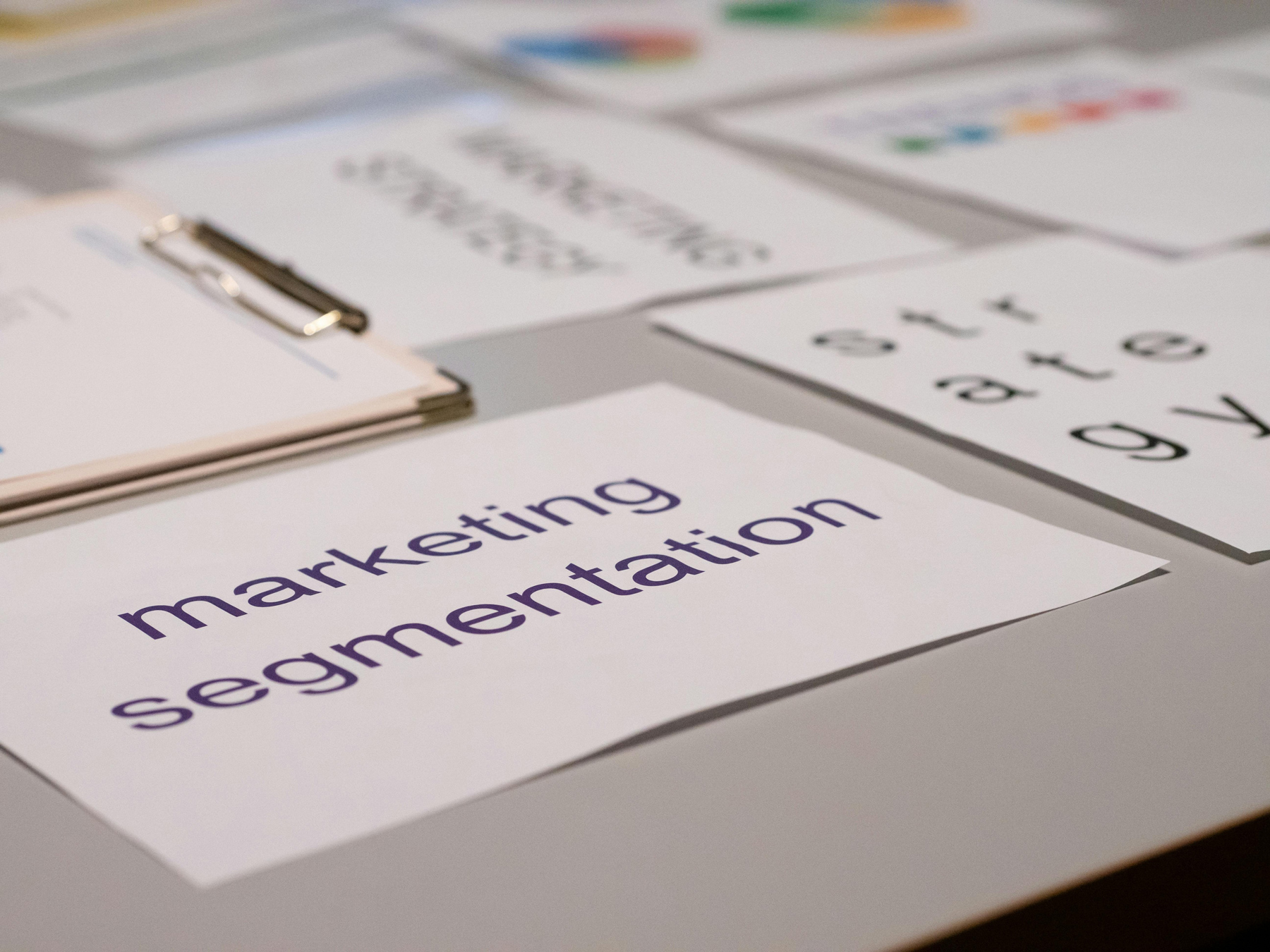 Desk with papers showing brand research, including colors and target audience, symbolizing the benefits of brand strategy for startups and small businesses.