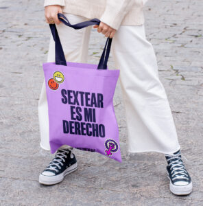 brand identity for activists branding services for small businesses Woman holding a purple tote bag with the message "Sexting is my right," standing on the street.