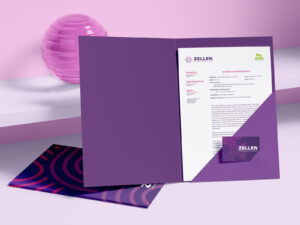 Open and closed Zellen-branded folders with business card, placed on a purple shelf with pink decor.