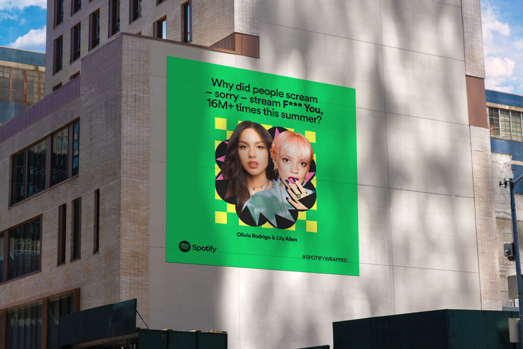 Spotify billboard in NYC with Olivia Rodrigo and Lily Allen showing edgy, humorous brand voice tone.