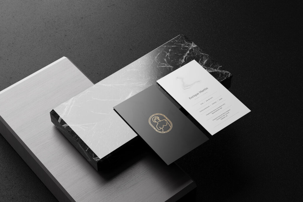 Mockup of Enrique Martin business cards showing logo and contact info, part of a professional logo design process.