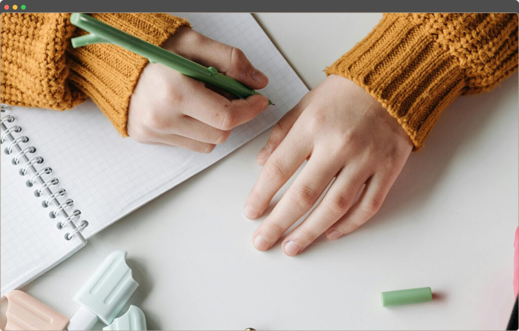 Woman sketching logo ideas by hand, an early part of the Enrique Martin logo design process.