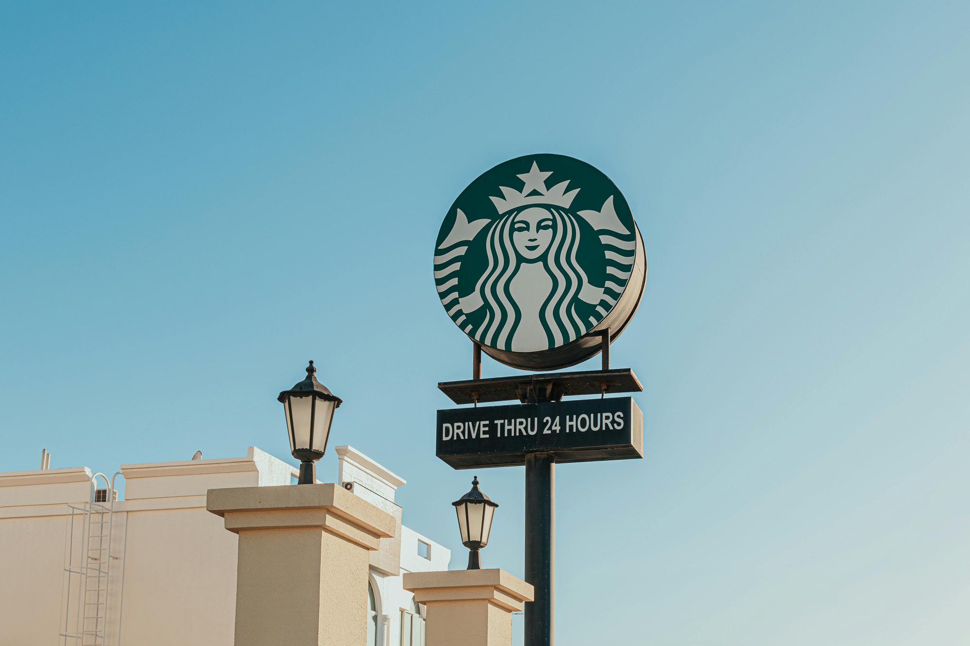 Starbucks logo sign outdoors showing how to build trust with my brand through recognition and consistency