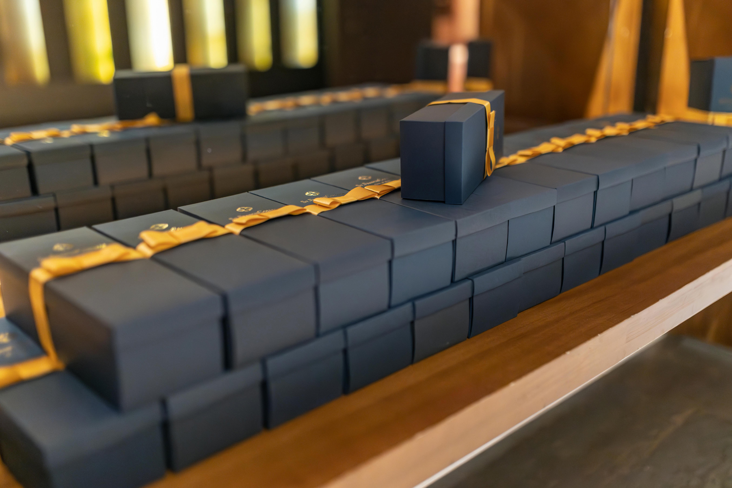 Luxury gift boxes with gold ribbons illustrating how to make my brand look premium through packaging and detail